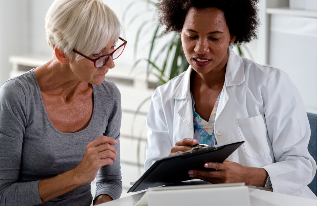 Healthcare professional discussing medical testing information with a patient during a clinical consultation